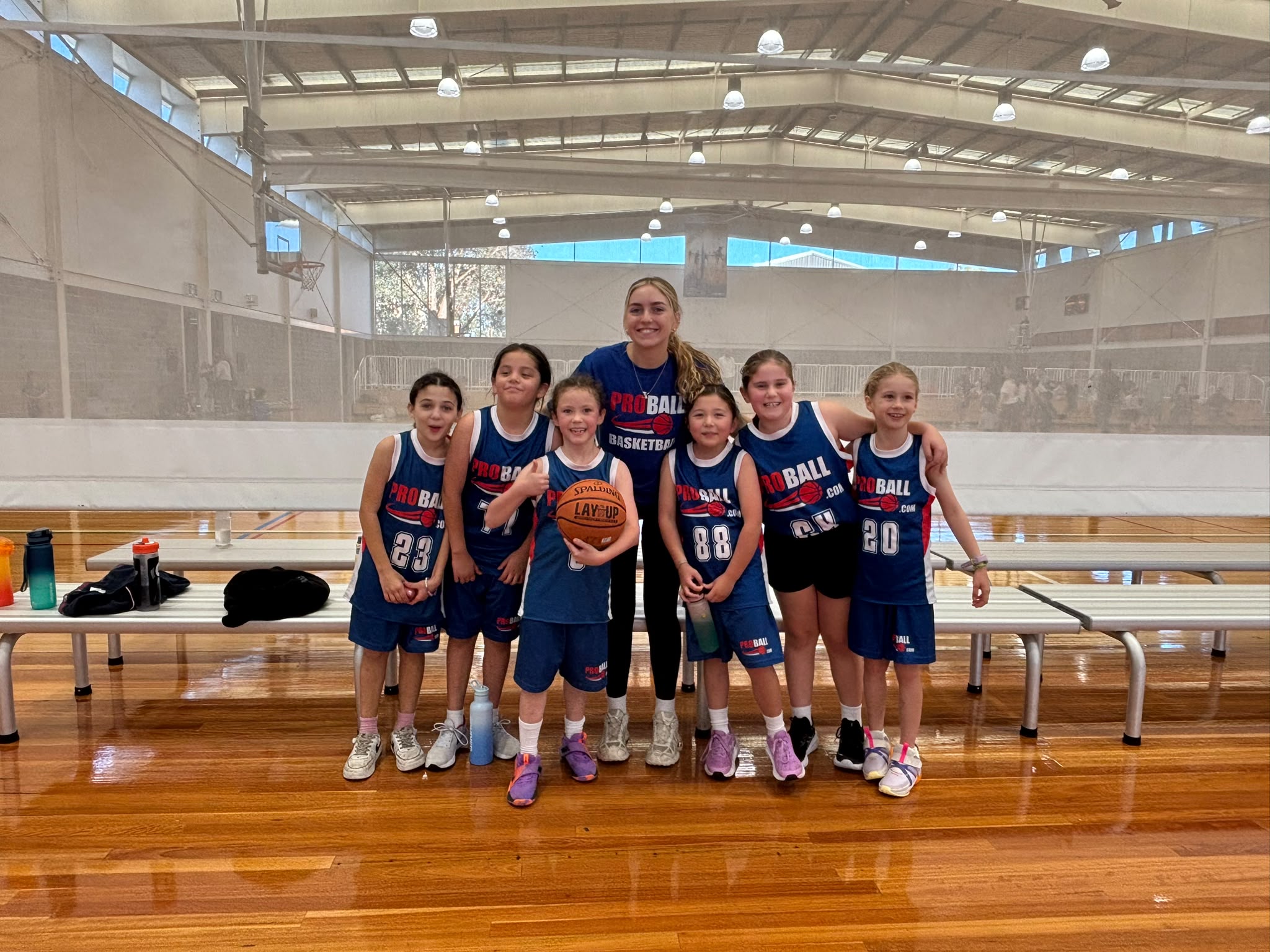 ProBall basketball team celebrating their first win together during a Saturday junior basketball game in Sydney.